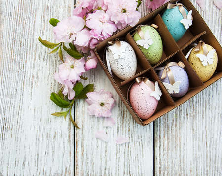 Easter eggs and sakura blossom on a old wooden backgroundの写真素材