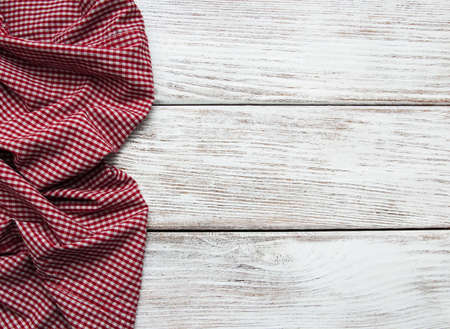 Checkered napkin on a old wooden  backgroundの写真素材