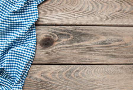 Checkered napkin on a old brown wooden background