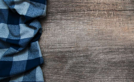 Checkered napkin on a old brown wooden backgroundの写真素材