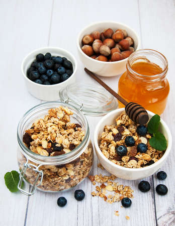 Bowl with granola and blueberries on a tableの写真素材