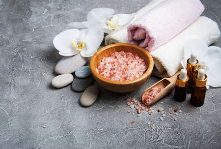Spa products with white orchids on a gray stone backgroundの写真素材