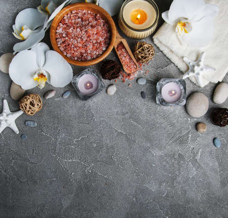 Spa products with white orchids on a gray stone backgroundの写真素材