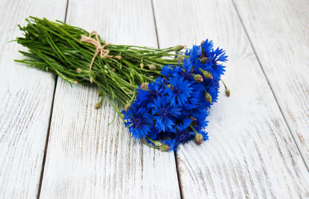 blue cornflowers on a old white wooden backgroundの写真素材