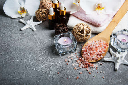 Spa products with white orchids on a gray stone backgroundの写真素材