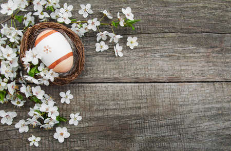 Easter eggs and spring  blossom on a old wooden background