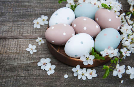 Easter eggs and spring  blossom on a old wooden background
