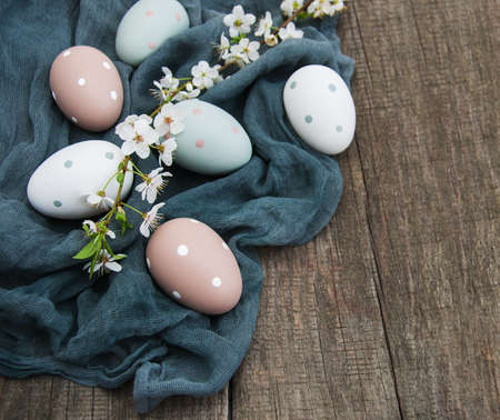 Easter eggs and spring  blossom on a old wooden background