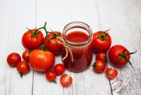 Jar with tomato sauce on a tableの写真素材
