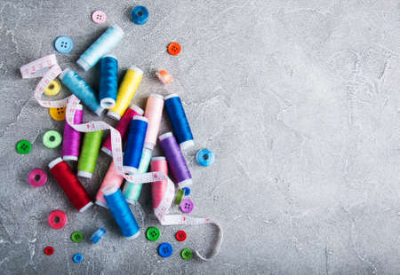 items for sewing on a gray stone background