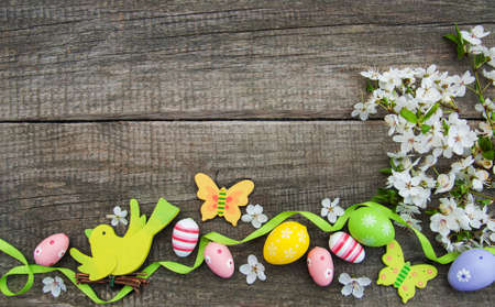 Easter eggs and spring  blossom on a old wooden backgroundの写真素材