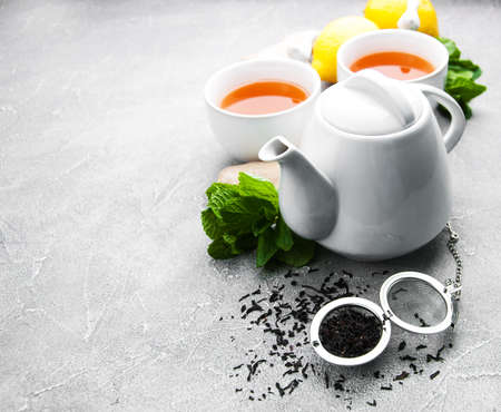 Tea with lemon and mint on a gray stone backgroundの写真素材