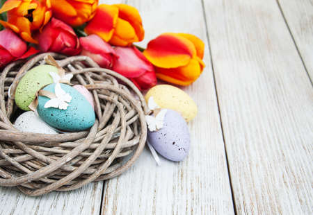 Easter egg in the nest  on a old wooden background