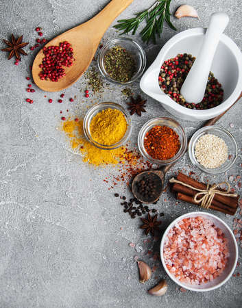 Different kind of spices in bowls on gray stone backgroundの写真素材