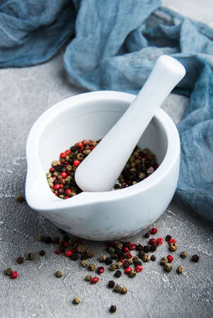 Pepper in a mortar on a gray stone backgroundの写真素材