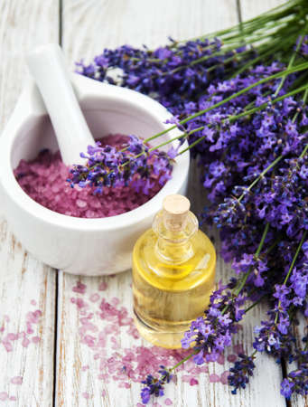 Spa products with lavender flowers on a tableの写真素材