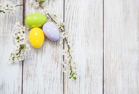 Easter eggs and spring  blossom on a old wooden backgroundの写真素材