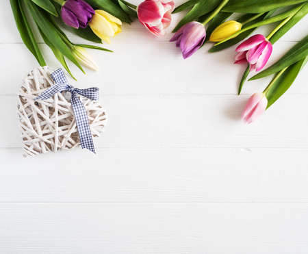 Spring tulips flowers on a white wooden backgroundの写真素材