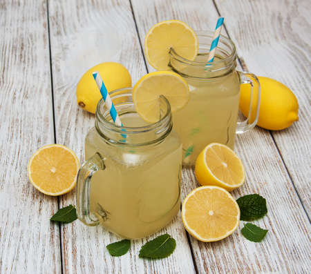 Jars of lemon juice on a old wooden tableの写真素材