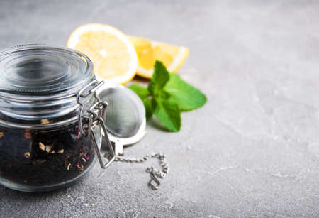 Jar with black tea on a gray stone backgroundの写真素材