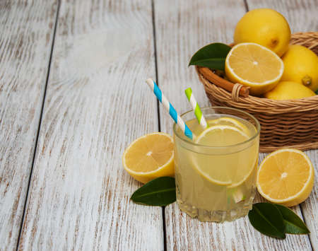 Glass of lemon juice on a old wooden tableの写真素材