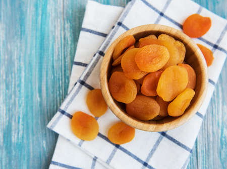 Dried apricots on a old wooden tableの写真素材