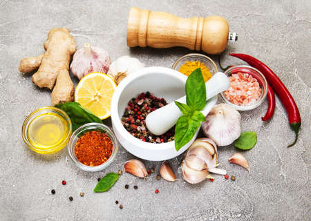 Different kind of spices on a  stone backgroundの写真素材