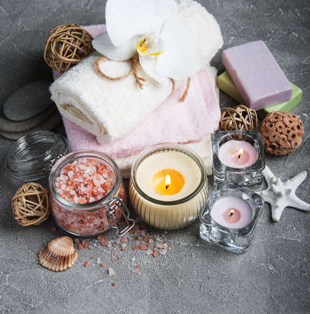 Spa products with white orchids on a gray stone backgroundの写真素材