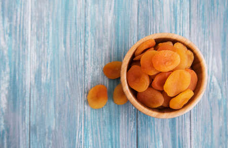 Dried apricots on a old wooden tableの写真素材