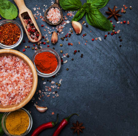 Different kind of spices  on black stone backgroundの写真素材