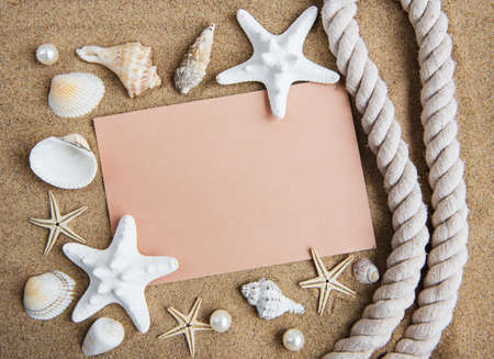 Holiday beach concept with shells, seastars and an blank postcardの写真素材