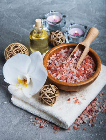 Spa products with white orchids on a gray stone backgroundの写真素材