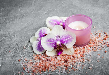 Spa products with orchids on a old gray stone backgroundの写真素材