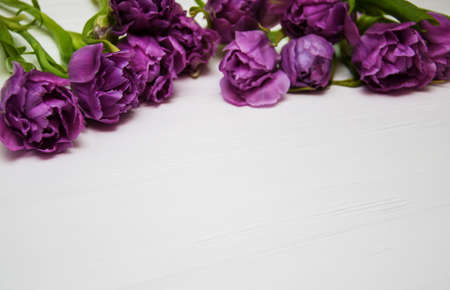 Spring tulip flowers on a white wooden table