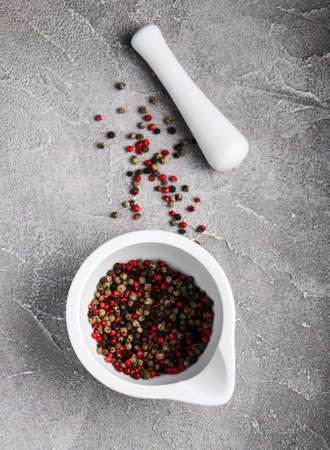 Pepper in a mortar on a gray stone background