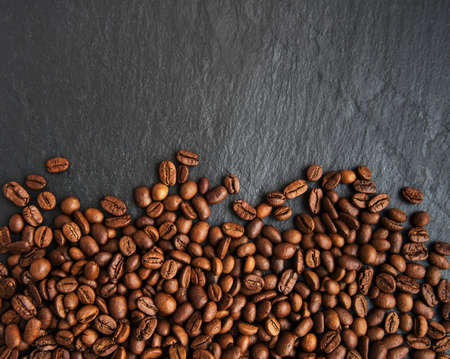 Coffee beans on a black stone background