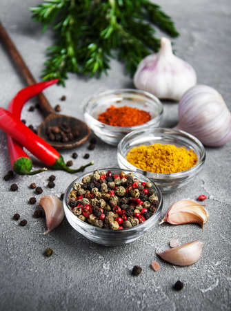 Different kind of spices in bowls on gray stone backgroundの写真素材