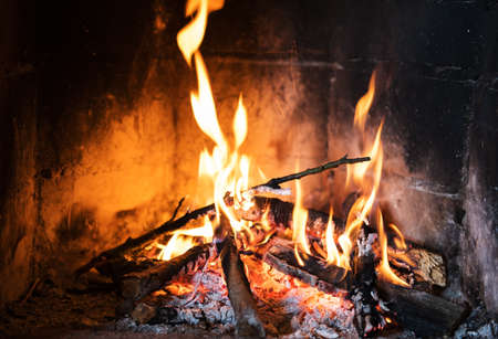 Burning and glowing pieces of wood in fireplaceの写真素材
