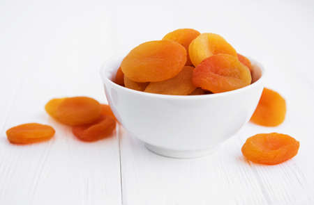 Dried apricots on a old wooden tableの写真素材