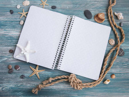 Shells,  sea decorations and notepad on white wooden tableの写真素材