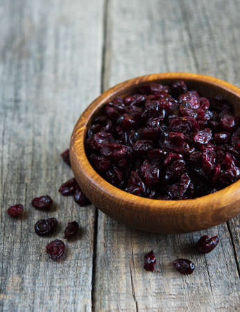 Dried cranberries on a old wooden tableの写真素材