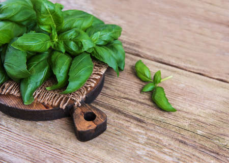 Fresh green basil herb on a old wooden backgroundの写真素材