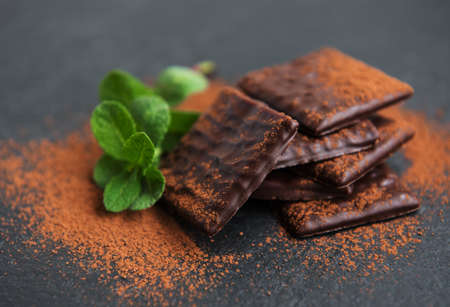 Chocolate and mint on a black stone backgroundの写真素材