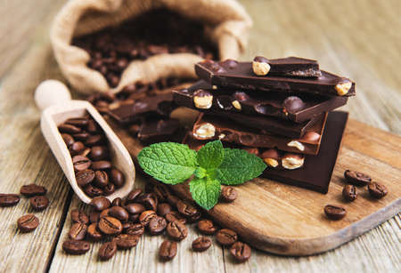 Chocolate and coffee beans on a old wooden table