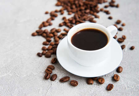 Cup of coffee and roasted coffee beansの写真素材