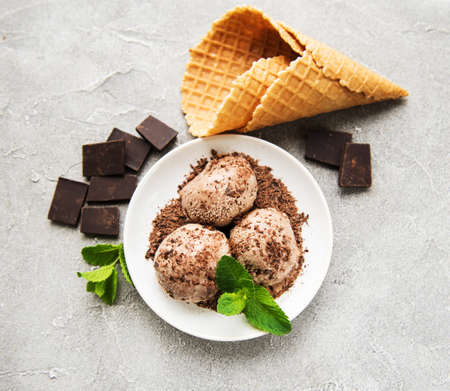 Plate with chocolate ice cream on a stone background