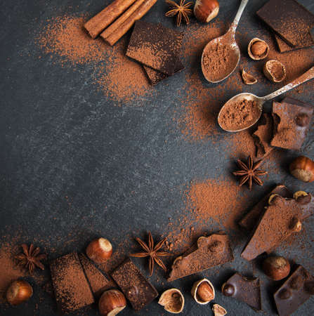 Chocolate and nuts on a black stone background