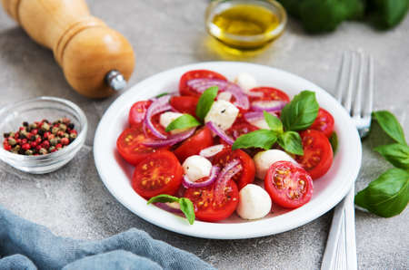 Italian caprese salad with cherry tomatoes and mozzarellaの写真素材