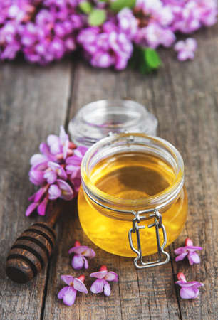 Honey with acacia blossoms on a old wooden backgroundの写真素材