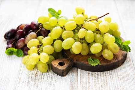 Fresh green grape on a old wooden table